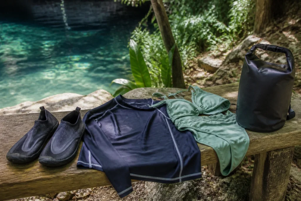 Water shoes and sun-protective clothing prepared for a cenote tour