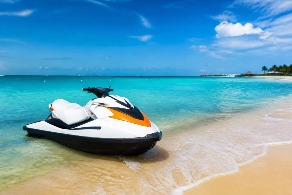 Personal watercraft near a sandy tropical beach before an open-water ride