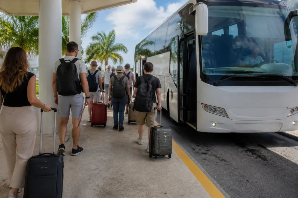 Travelers boarding an airport coach with luggage
