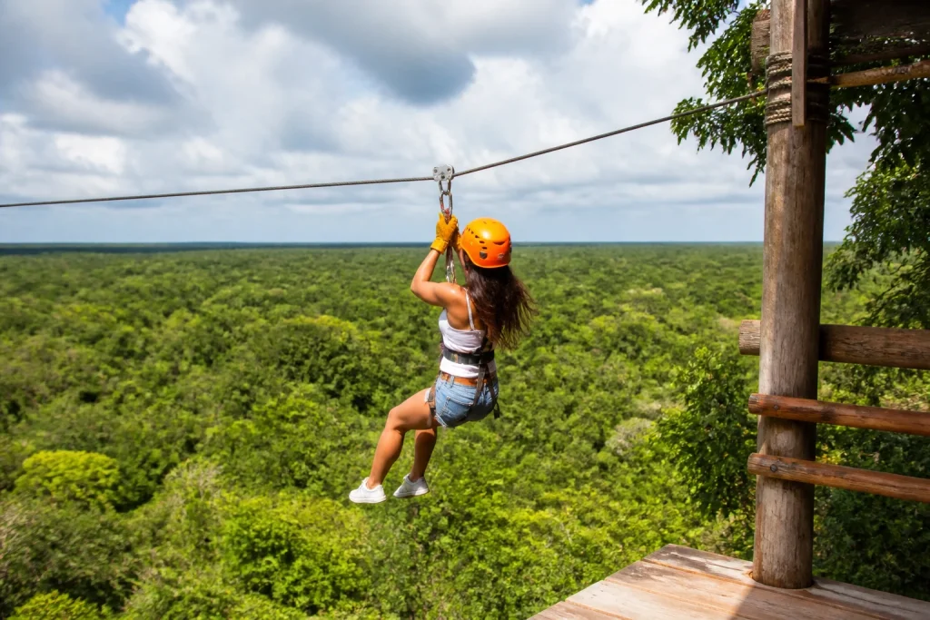 Traveler preparing for a zipline activity above tropical forest