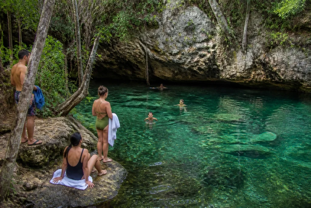 Travelers preparing to swim in a jungle cenote near Cancun
