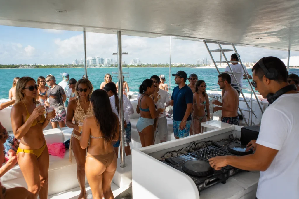 Social atmosphere aboard a Cancun catamaran party cruise