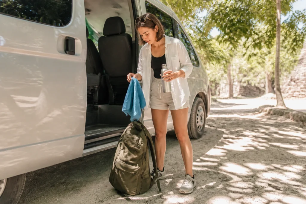 Traveler packing a small day bag for a Coba and cenote excursion