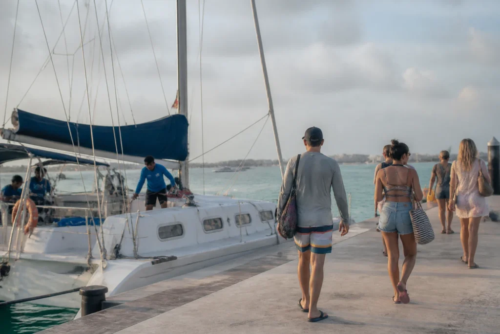 Travelers preparing to board a Cancun catamaran for Isla Mujeres