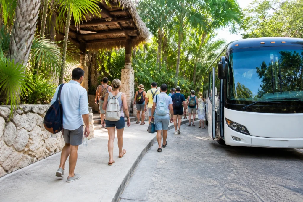 Tour transportation arriving at a tropical Riviera Maya park