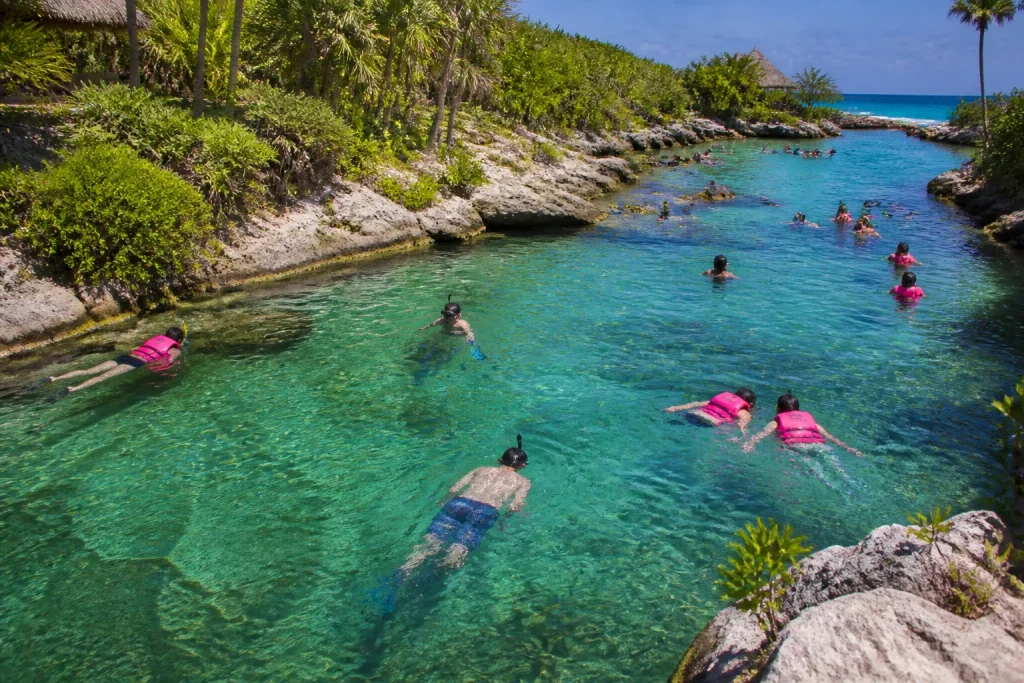 Travelers swimming and snorkeling in a tropical coastal inlet